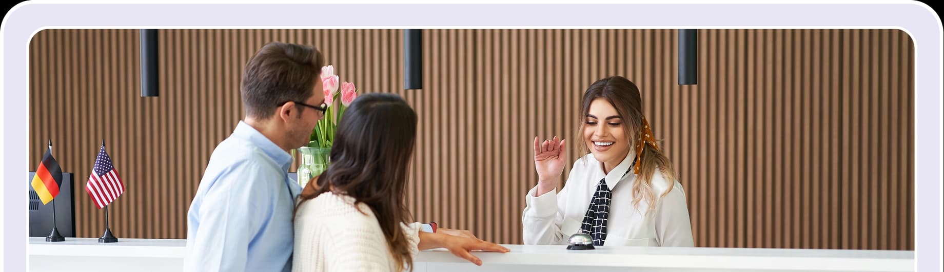 Hotel reception staff welcoming guests at the front desk