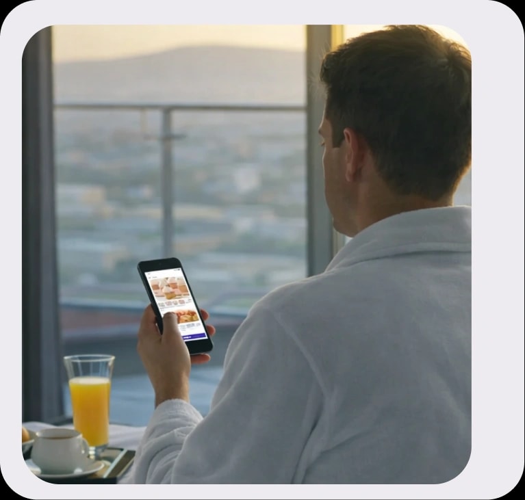 Guest using mobile app in hotel robe